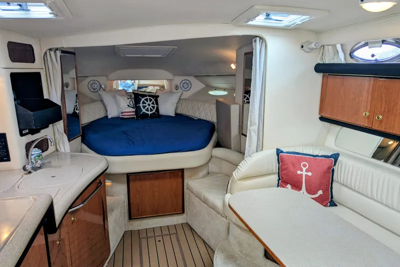 Slide: The Image of Interior of 2001 Sea Ray 340 Sundancer yacht with cozy cabin and nautical decor. - 8