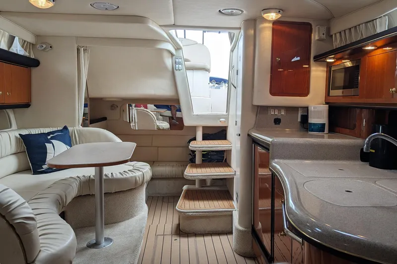Slide: The Image of Luxurious interior of 2001 Sea Ray 340 Sundancer yacht with kitchen and seating area. - 9