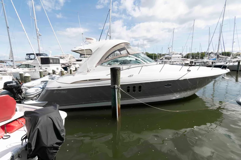 The Image of 2007 Cruisers Yachts 420 Express docked in a marina under a clear sky. - 0
