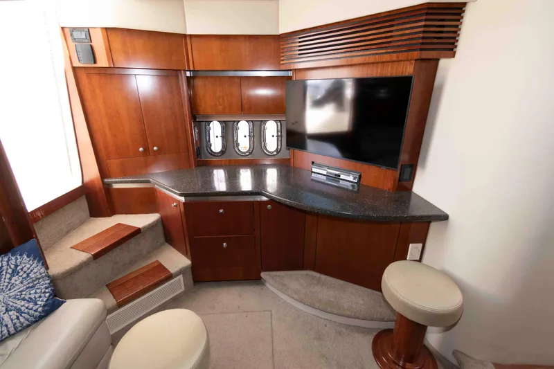 Slide: The Image of Luxurious 2007 Cruisers Yachts 420 Express interior with TV, wooden cabinetry, and seating. - 10
