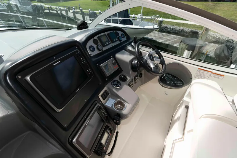 Slide: The Image of 2007 Cruisers Yachts 420 Express helm with modern navigation equipment and steering wheel. - 6