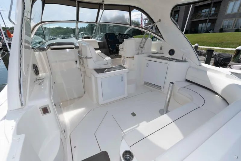 Slide: The Image of 2007 Cruisers Yachts 420 Express interior with seating and helm, docked at marina. - 3