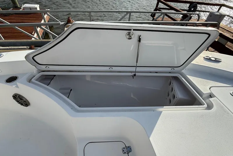Slide: The Image of Open storage compartment on 2015 Sportsman Masters 247 Bay Boat, dockside view. - 10