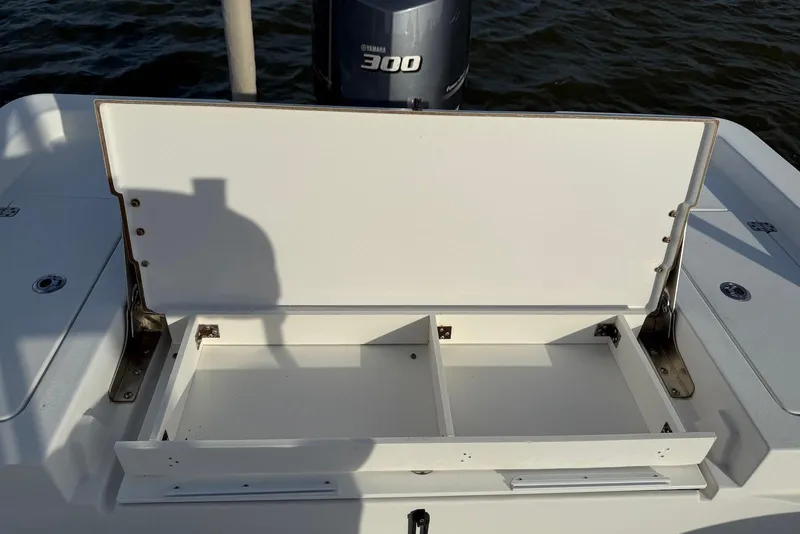Slide: The Image of Open storage compartment on 2015 Sportsman Masters 247 Bay Boat, with Yamaha 300 engine. - 16