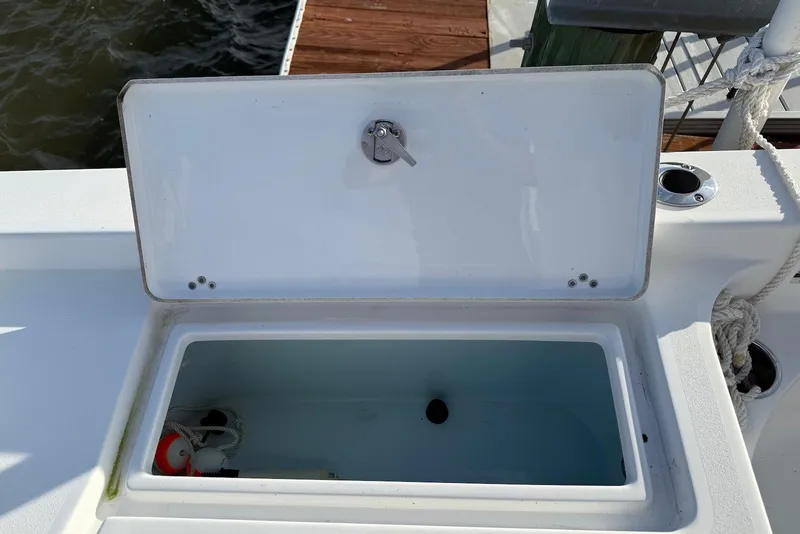 Slide: The Image of Open storage compartment on a 2015 Sportsman Masters 247 Bay Boat, dockside view. - 18