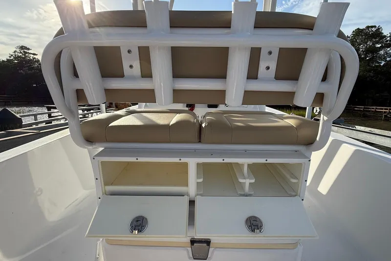 Slide: The Image of 2015 Sportsman Masters 247 Bay Boat with open storage compartments and cushioned seating. - 20