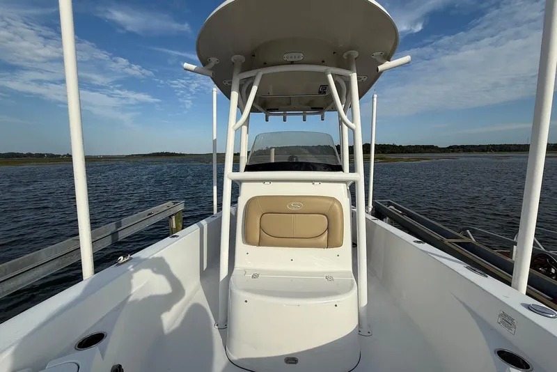 Slide: The Image of 2015 Sportsman Masters 247 Bay Boat on calm water, featuring a center console and T-top. - 6