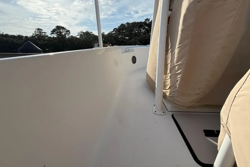 Slide: The Image of 2015 Sportsman Masters 247 Bay Boat deck view with beige seating and clear sky. - 9