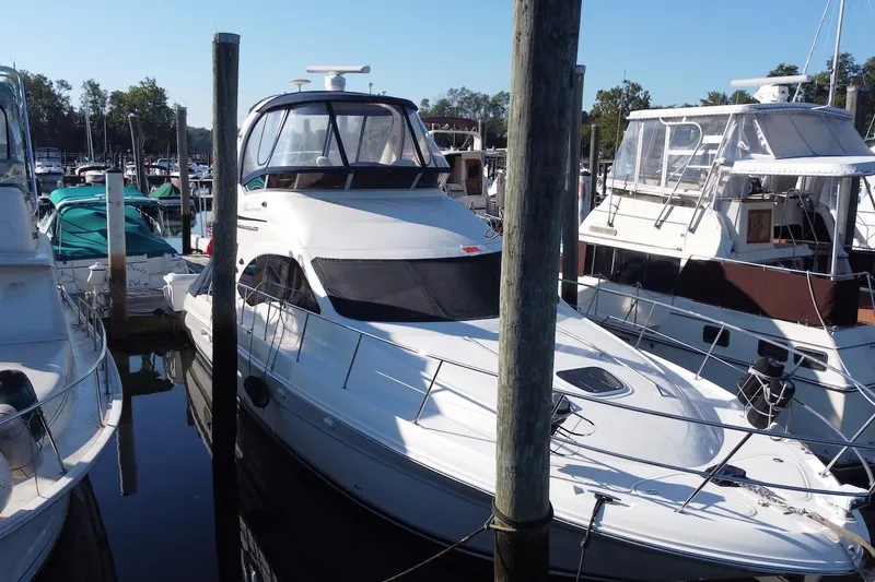 The Image of 2005 Sea Ray 420 Sedan Bridge yacht on calm water, side view. - 0