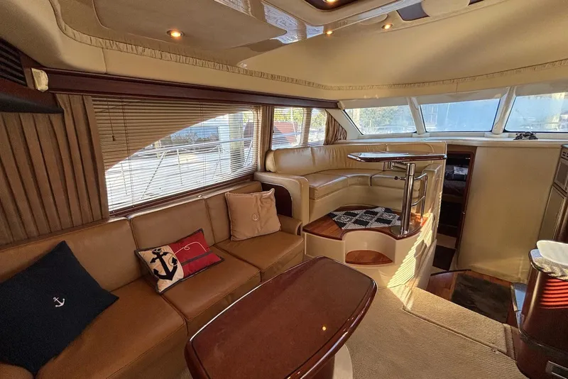 Slide: The Image of Luxurious interior of 2005 Sea Ray 420 Sedan Bridge with panoramic windows and plush seating. - 10