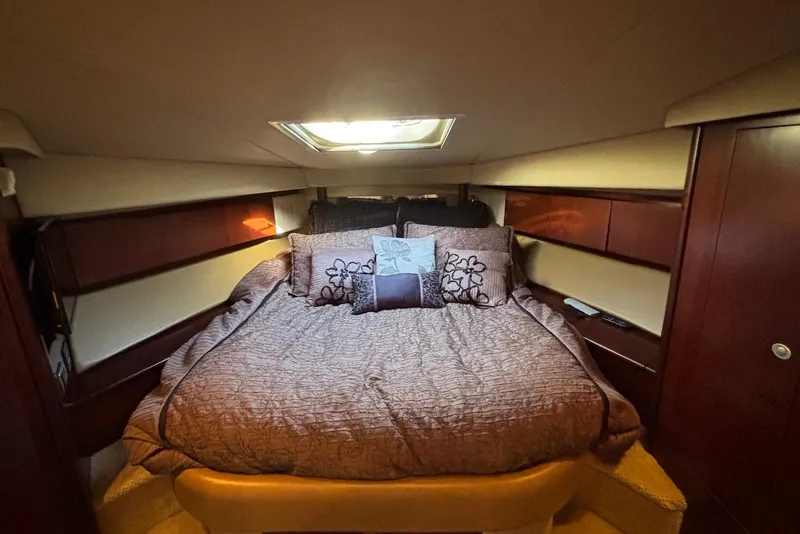 Slide: The Image of Luxurious interior of 2005 Sea Ray 420 Sedan Bridge with leather seating and nautical decor. - 16