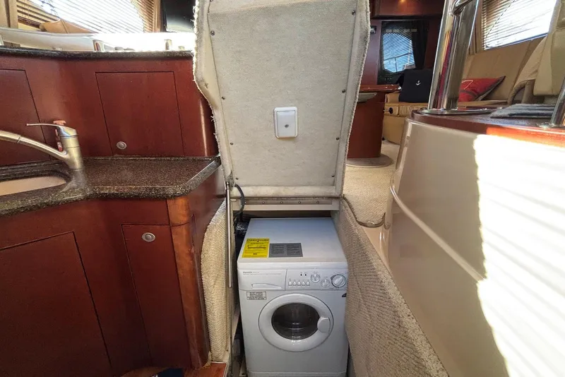 Slide: The Image of Interior of 2005 Sea Ray 420 Sedan Bridge yacht with kitchen and seating area. - 18