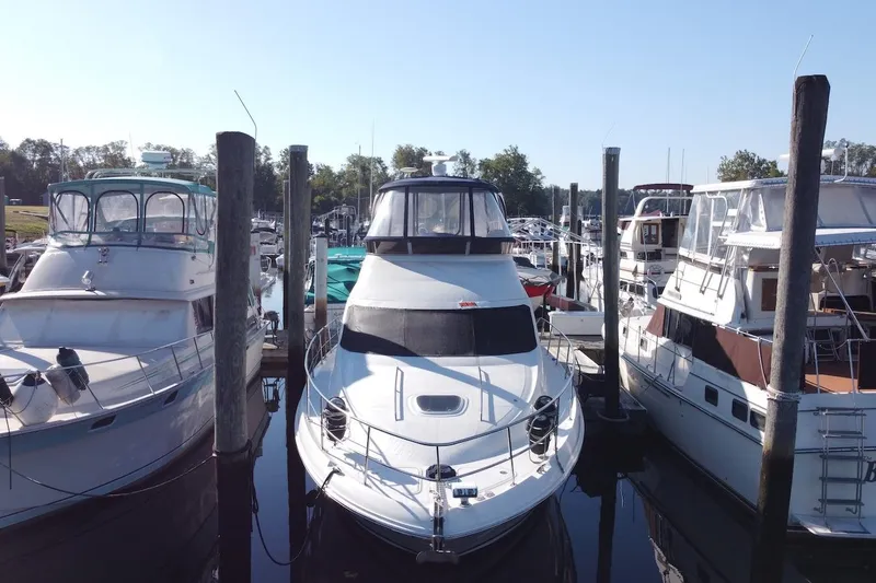 Slide: The Image of 2005 Sea Ray 420 Sedan Bridge cruising on a river near a bridge. - 2