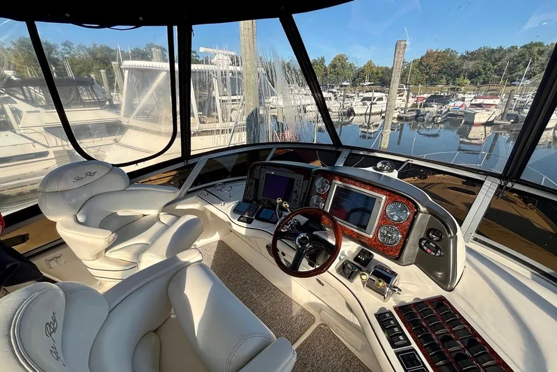 Slide: The Image of 2005 Sea Ray 420 Sedan Bridge yacht docked between two boats. - 5