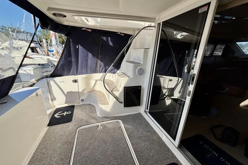 Slide: The Image of 2005 Sea Ray 420 Sedan Bridge helm with panoramic marina view, featuring modern navigation equipment. - 8