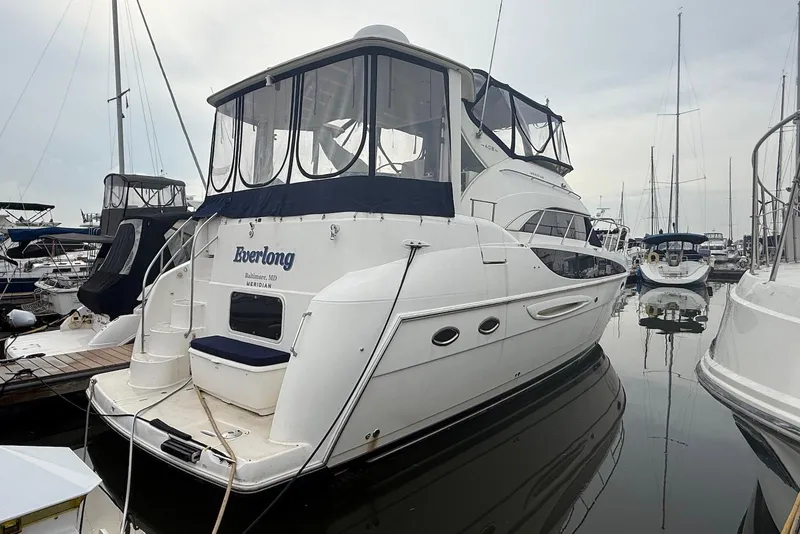 The Image of 2004 Meridian 408 Motoryacht docked at marina under blue sky. - 0