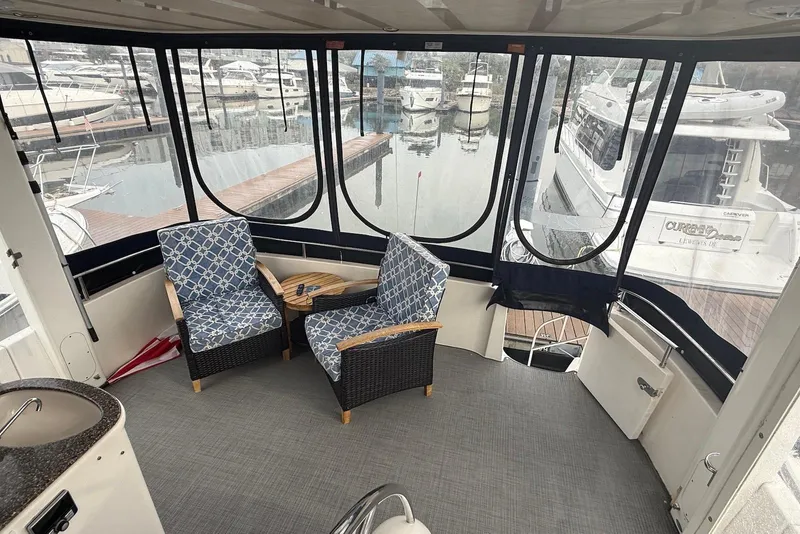 Slide: The Image of 2004 Meridian 408 Motoryacht interior with seating, TV, and marina view. - 2