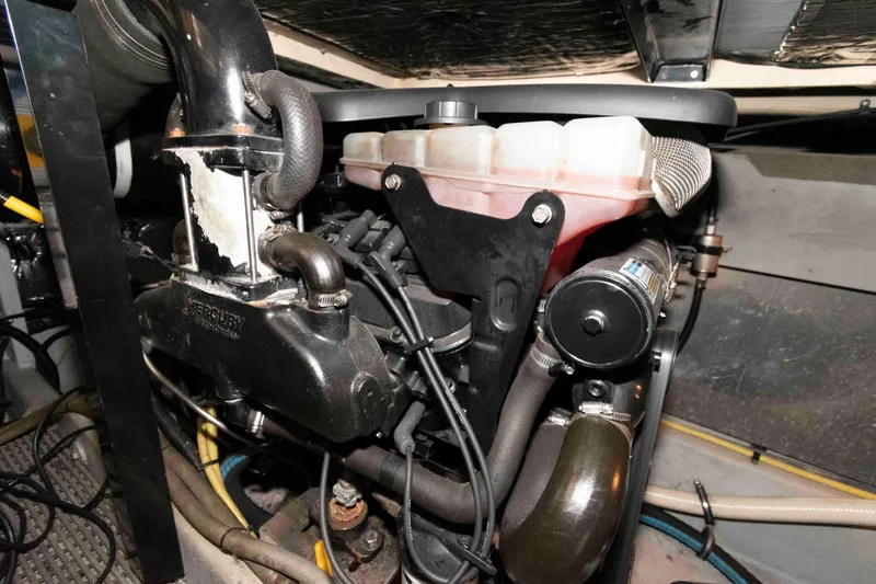 Slide: The Image of Engine compartment of a 2004 Meridian 408 Motoryacht, showcasing mechanical components and hoses. - 25