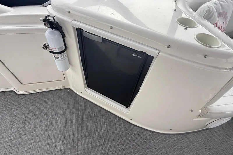 Slide: The Image of 2004 Meridian 408 Motoryacht interior with marina view, featuring two patterned chairs and a wooden table. - 4