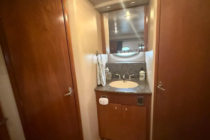 Slide: The Image of 2004 Meridian 408 Motoryacht helm with marina view, featuring navigation controls and steering wheel. - 9