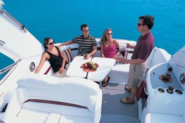 Slide: The Image of 2008 Formula 31 Performance Cruiser docked with American flag, turquoise building backdrop. - 1