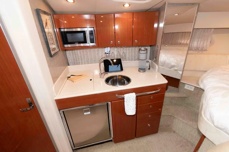Slide: The Image of 2008 Formula 31 Performance Cruiser interior with kitchenette, featuring wood cabinets and modern appliances. - 13