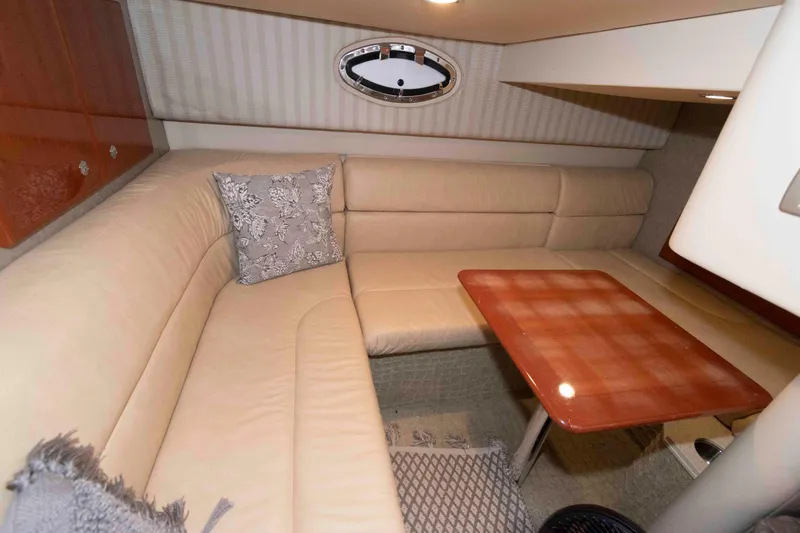 Slide: The Image of 2008 Formula 31 Performance Cruiser interior with beige seating and wooden table. - 16