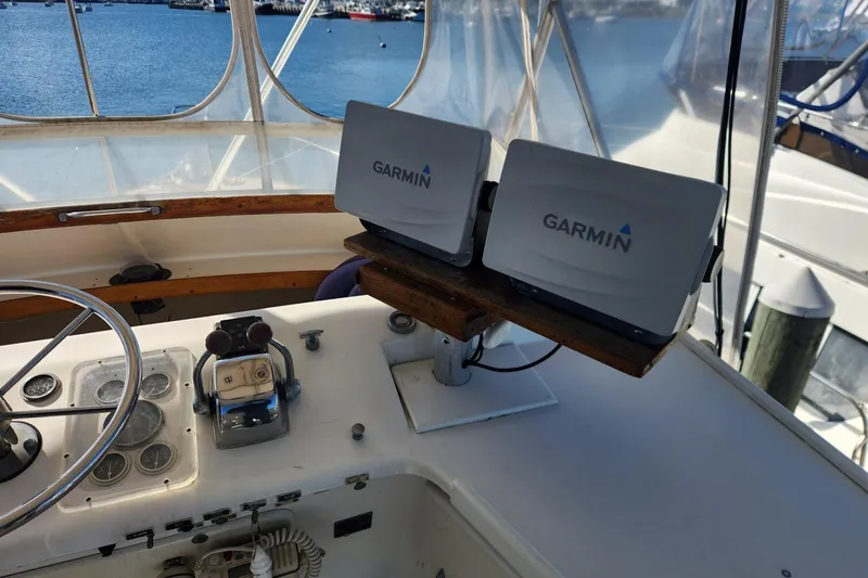Slide: The Image of 1977 Post Sport Fish boat helm with Garmin navigation systems, overlooking marina. - 11