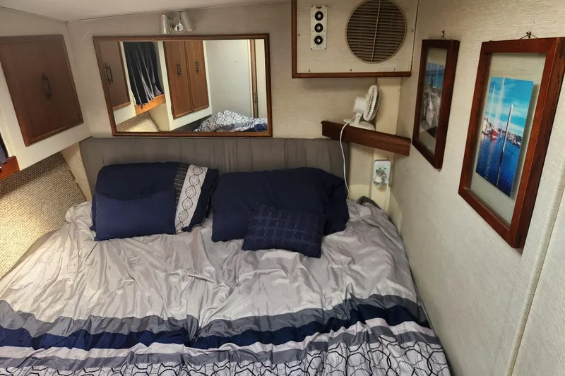 Slide: The Image of Cozy cabin interior of a 1977 Post Sport Fish boat with nautical decor. - 14