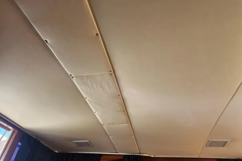 Slide: The Image of 1977 Post Sport Fish boat interior ceiling with beige panels and recessed lighting. - 15