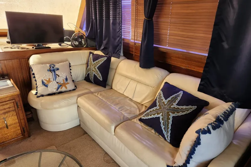 Slide: The Image of 1977 Post Sport Fish interior with nautical-themed pillows and cozy seating area. - 22