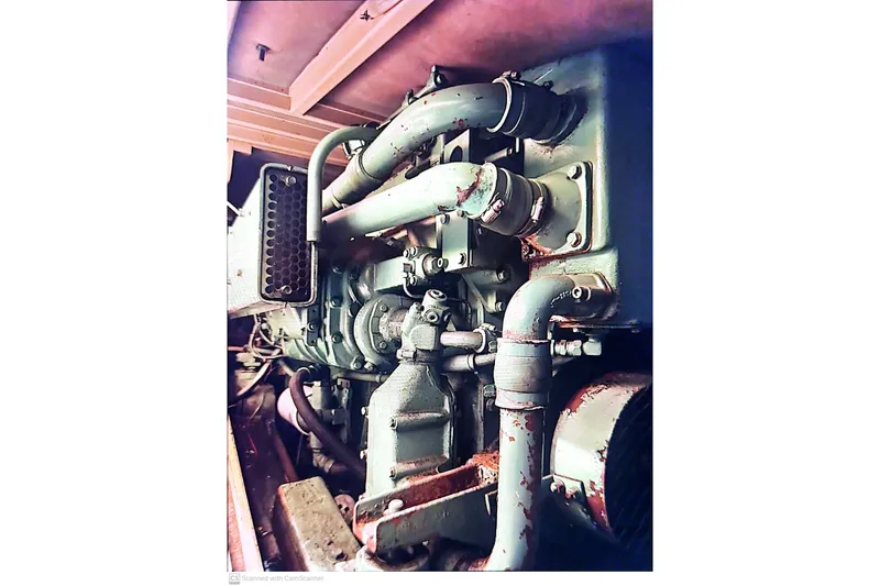 Slide: The Image of 1977 Post Sport Fish engine with visible pipes and components. - 24