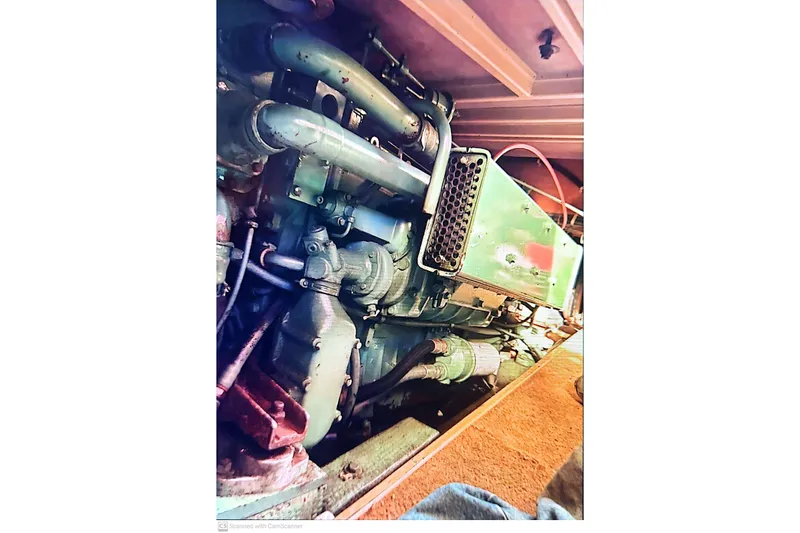 Slide: The Image of 1977 Post Sport Fish engine compartment with visible pipes and components. - 25