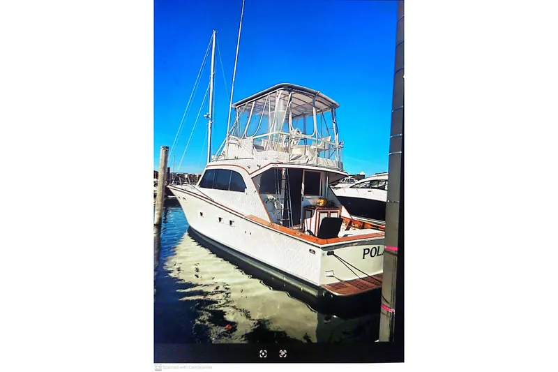 Slide: The Image of 1977 Post Sport Fish boat docked in marina under clear blue sky. - 3