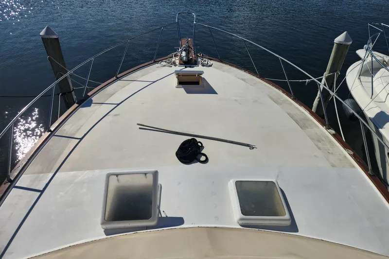 Slide: The Image of 1977 Post Sport Fish boat deck with hatches, docked on calm water. - 4