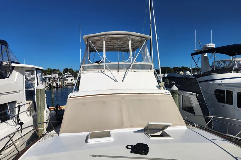 Slide: The Image of 1977 Post Sport Fish boat docked at marina under clear blue sky. - 5
