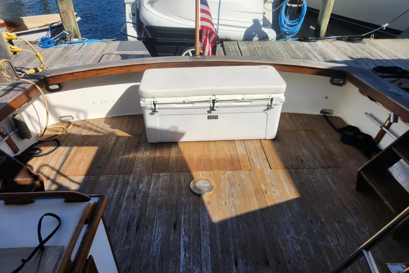 Slide: The Image of 1977 Post Sport Fish boat deck with cooler, docked at marina. - 7