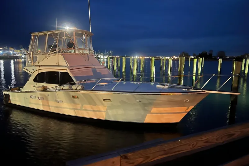 The Image of 1977 Post Sport Fish boat docked at night, illuminated by soft lights. - 0