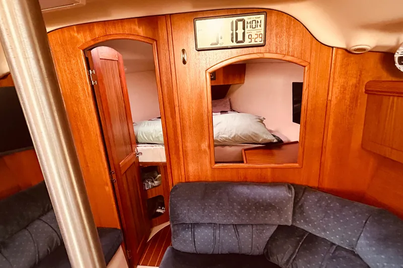 Slide: The Image of Interior of 2003 Hunter 386 sailboat with cozy cabin and wooden finish. - 27