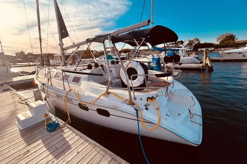 Slide: The Image of Hunter 386 sailboat from 2003 docked at a marina under a clear blue sky. - 3