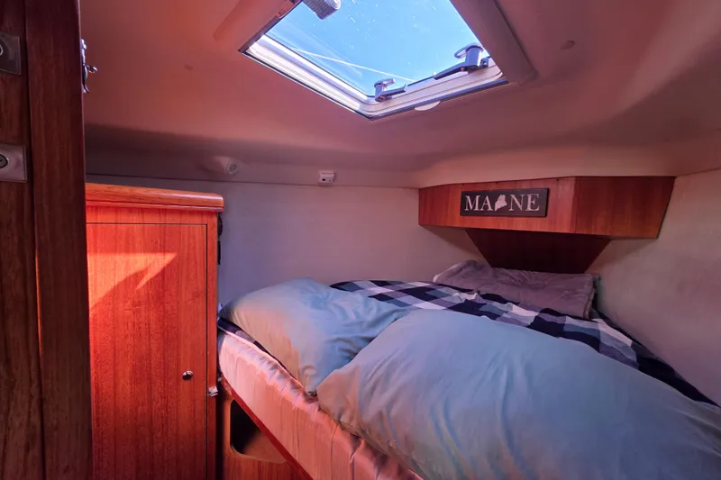 Slide: The Image of Cozy cabin interior of 2003 Hunter 386 sailboat with skylight and wooden furnishings. - 31