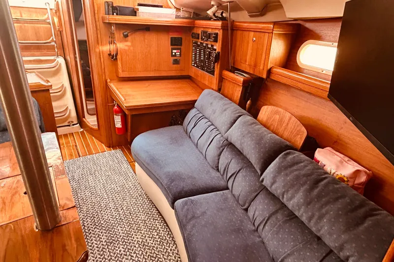 Slide: The Image of Interior of 2003 Hunter 386 sailboat with cozy seating and wooden cabinetry. - 36