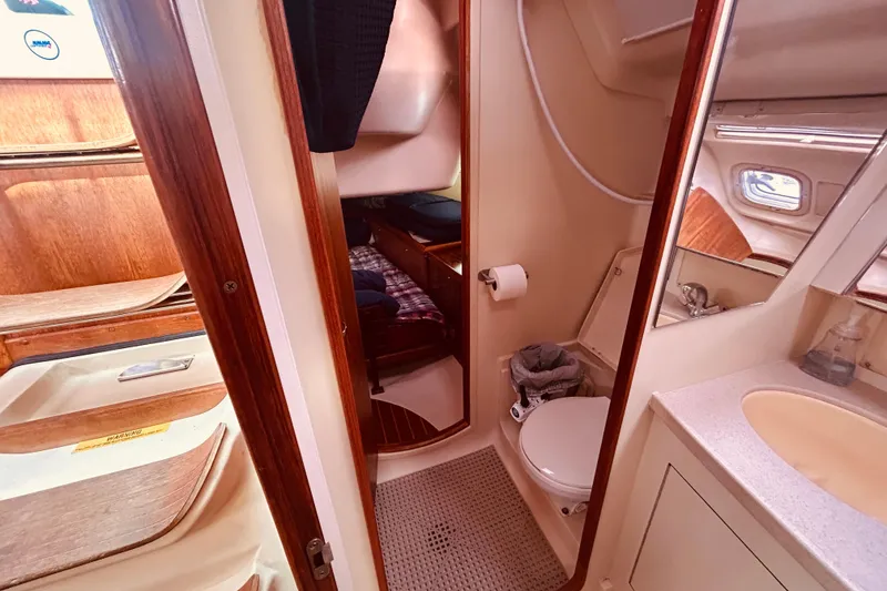 Slide: The Image of Interior of 2003 Hunter 386 sailboat showing bathroom and cabin area. - 39