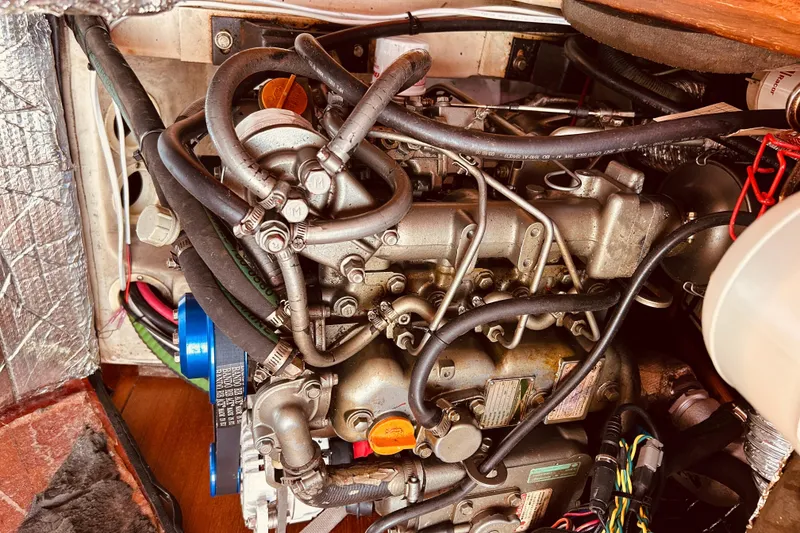 Slide: The Image of Engine of a 2003 Hunter 386 sailboat with visible hoses and components. - 41