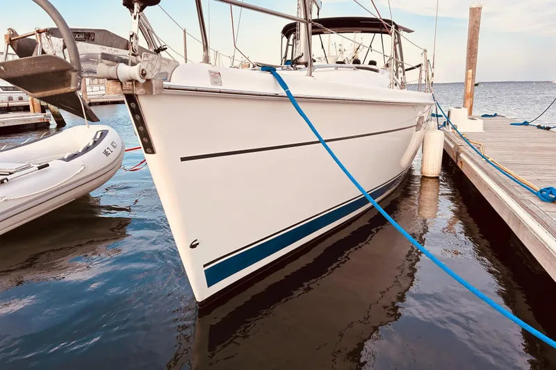 Slide: The Image of Hunter 386 sailboat from 2003 docked at a marina, with blue mooring lines. - 5