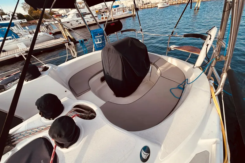 Slide: The Image of 2003 Hunter 386 sailboat cockpit with covered steering wheel, docked at marina. - 6