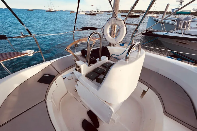 Slide: The Image of Cockpit of 2003 Hunter 386 sailboat with ocean view and moored vessels. - 7