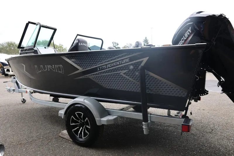 Slide: The Image of 2026 Lund 1775 Adventure Sport boat on trailer, featuring sleek design and Mercury engine. - 10
