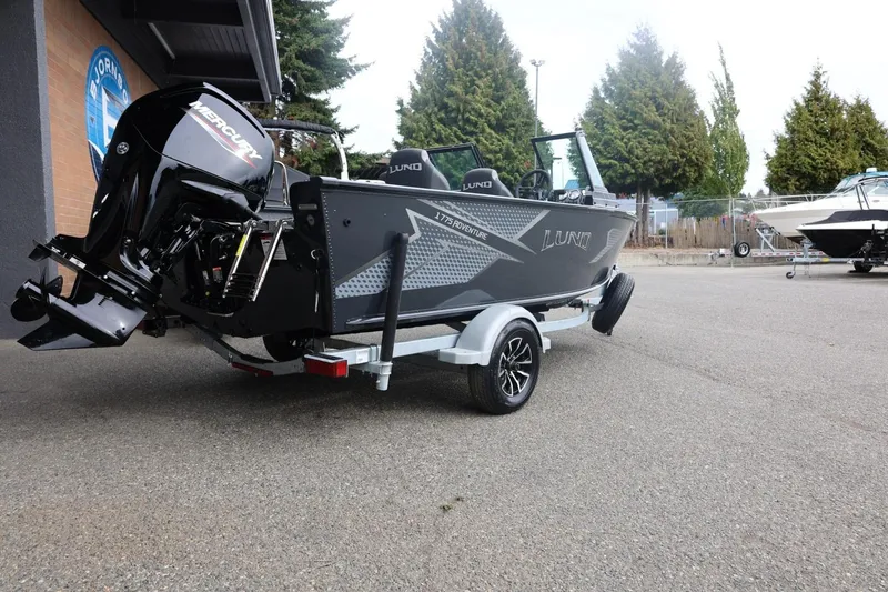 Slide: The Image of 2026 Lund 1775 Adventure Sport boat on trailer, featuring Mercury outboard motor. - 15