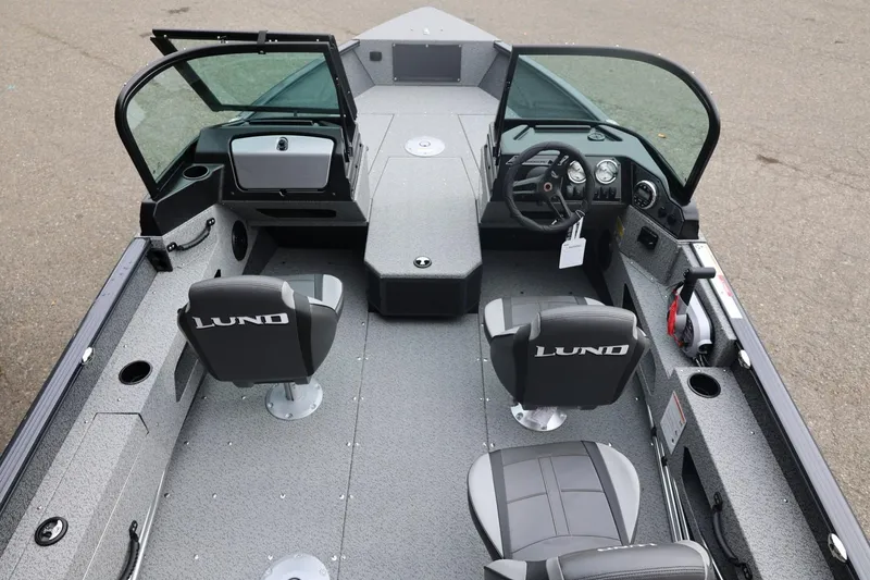 Slide: The Image of 2026 Lund 1775 Adventure Sport boat interior with seating and steering console. - 17